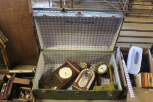 A travelling trunk containing a wall clock, mantel