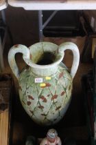 A large twin handled green painted urn AF