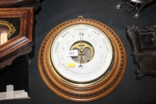 A oak cased circular barometer