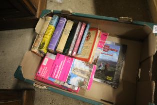 A box containing various travel books and ordnance
