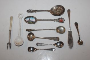 A collection of silver and white metal spoons, one