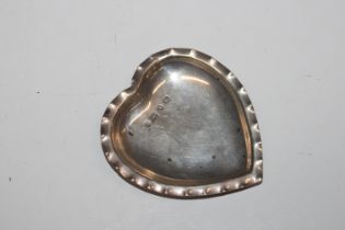 A silver heart shaped pin dish with crimped edge d