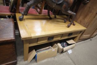 A modern oak coffee table fitted four drawers