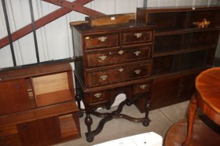 A reproduction chest on stand fitted two short ove