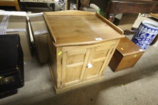 A dwarf stripped pine two door cupboard with gallery top