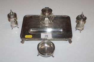 A silver plated desk stand with a cut glass inkwell; a silver salt and two white metal