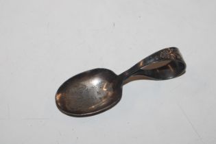 A sterling silver feeding spoon with engraving of