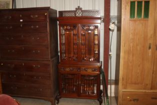 A glazed mahogany cabinet, upper section fitted th