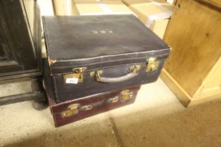 Two leather suitcases both with silk linings
