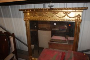 A gilt framed bevel edged oval mantel mirror