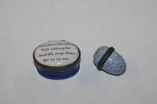 An enamel egg shaped thimble holder and an enamel