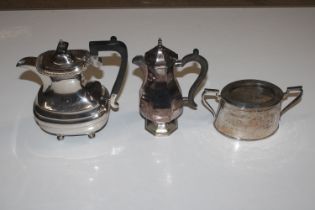 A silver plated coffee pot; water jug and sugar bo