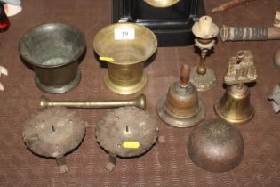 A collection of metalware to include pestle and mortar; hand bells; candle stands etc