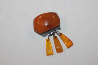 A Continental silver mounted amber set brooch with