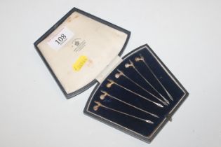 A cased set of six cocktail sticks with cockerel f