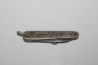 A silver multi tool including knife; button hook e