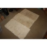 Three cream wool rugs
