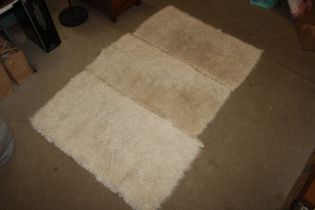 Three cream wool rugs