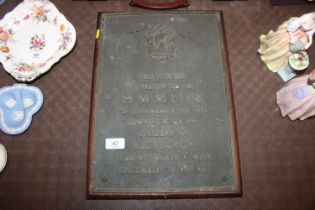 A mounted plaque "The Plaque is Presented to H. M.
