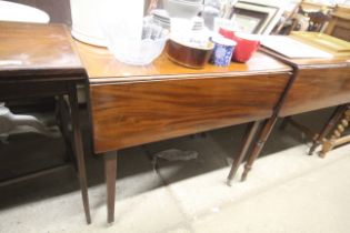 A 19th Century Pembroke table raised on square tap