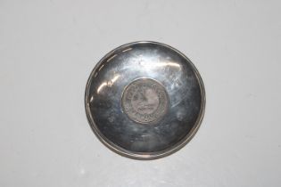 A silver dish with Millennium five pound coin to c