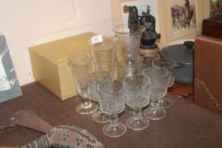 An engraved glass vase; three glass measures and six Whitefriars style glasses