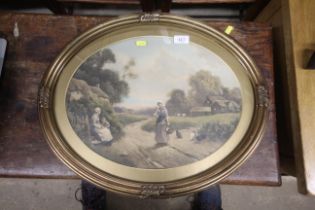 A gilt framed oval print depicting a country scene