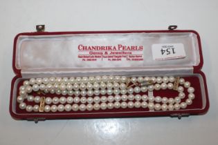 A boxed Chandrika pearl necklace