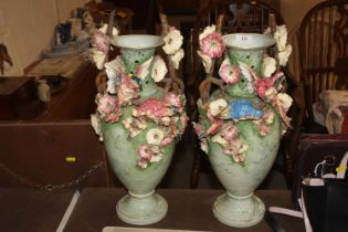 A pair of Majolica style vases decorated with bird