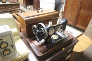 A Firster and Rossmann hand sewing machine and fitted case