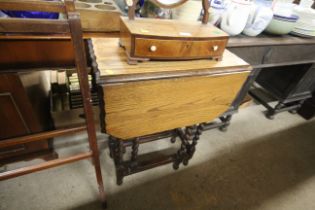 An oak barley twist drop leaf table