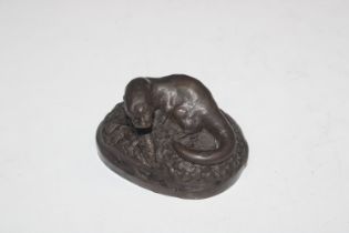 A bronzed group depicting an otter, signed to the