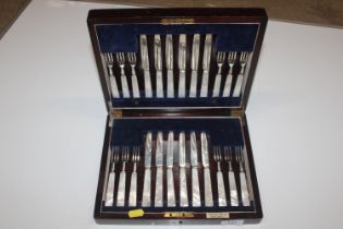 A canteen of 12 each Mappin & Webb silver bladed and silver tined mother of pearl handled fruit