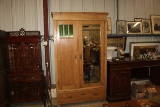 A stripped pine mirror fronted two door wardrobe f