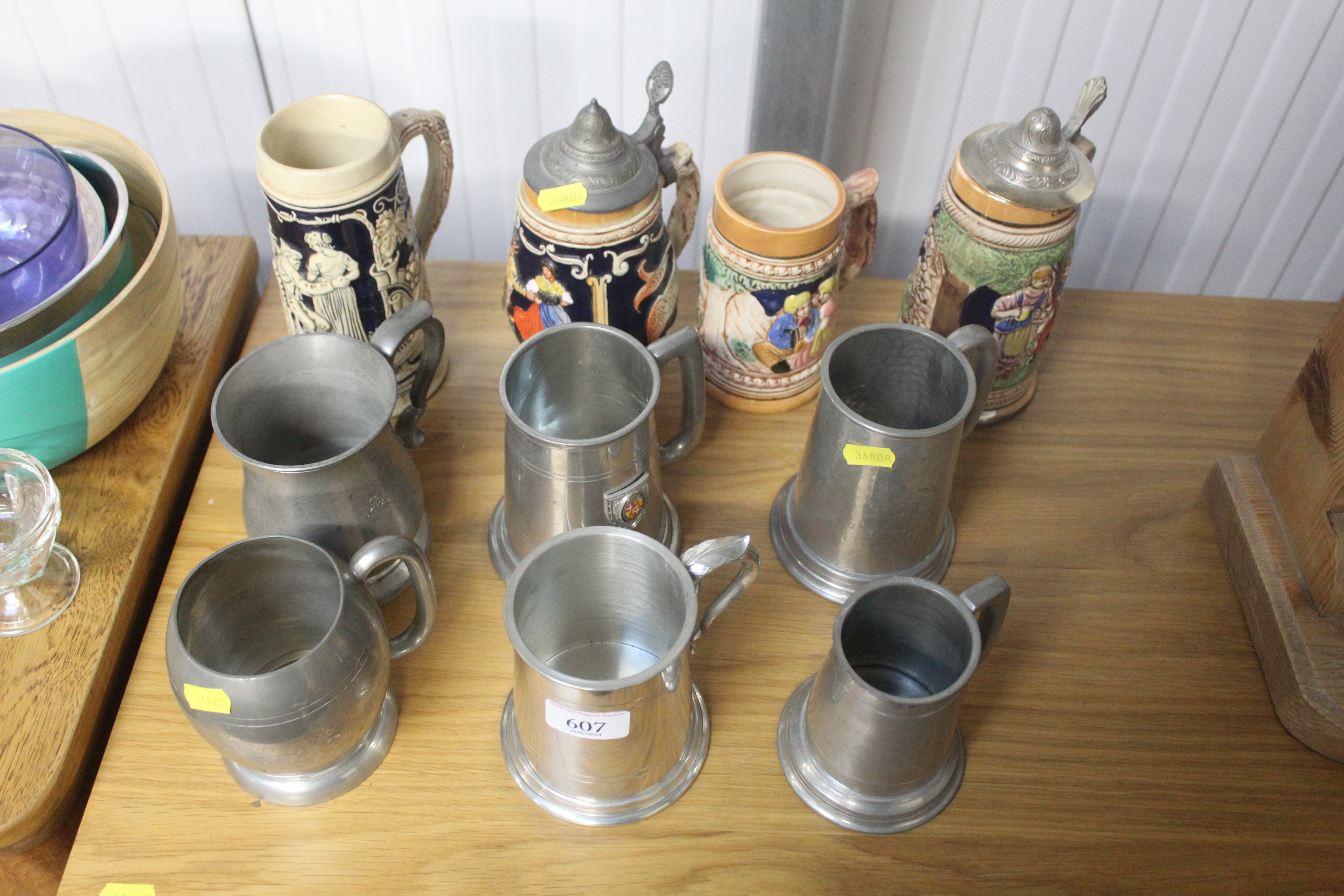 A collection of beer steins and pewter tankards
