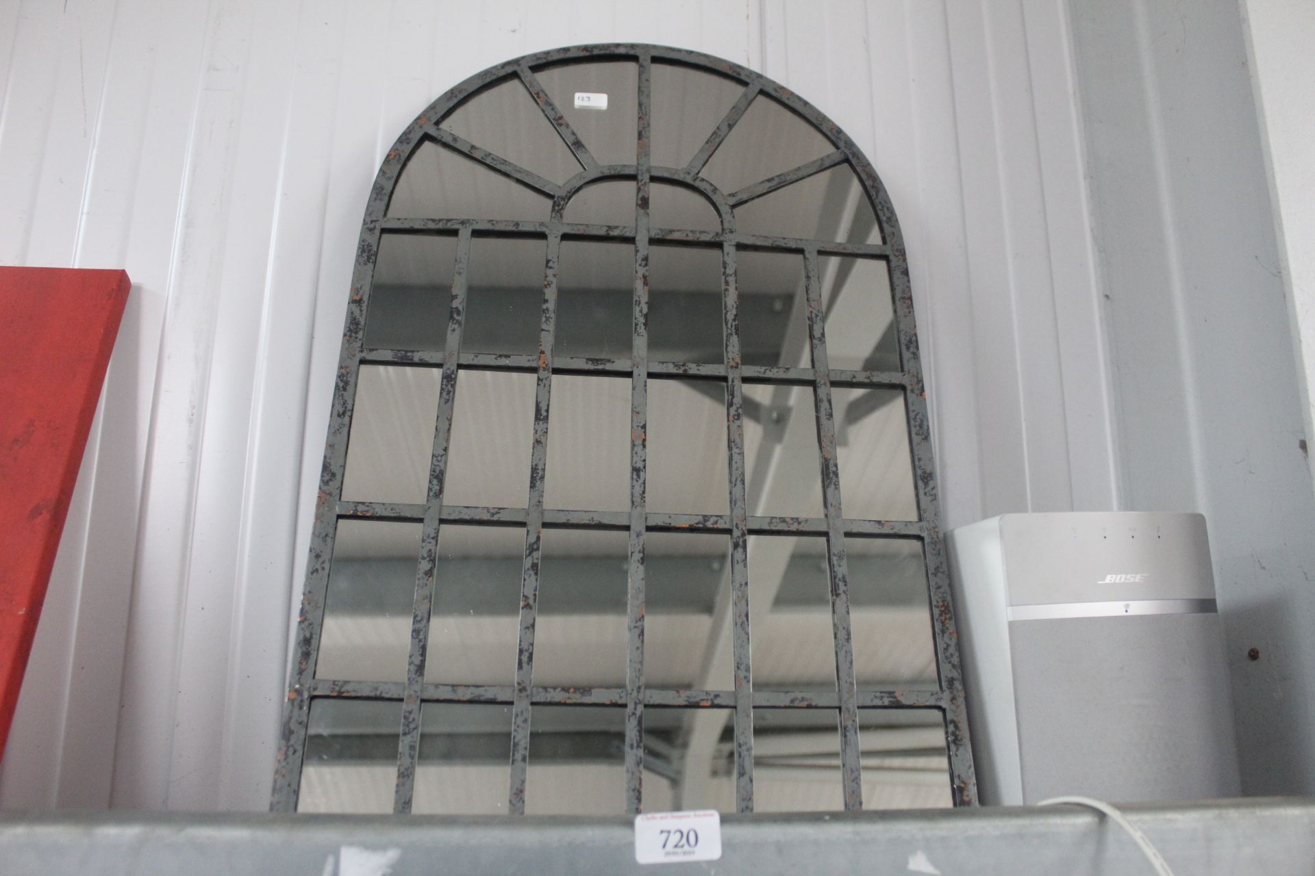 An arch framed wall mirror (123)