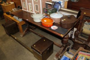 An oak refectory table raised on stretchered base