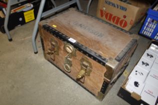 A metal bound wooden traveling trunk of small prop