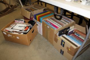 Five boxes containing various books: LPs and other