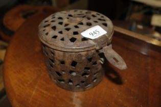 A pierced metal canister