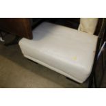 An upholstered footstool