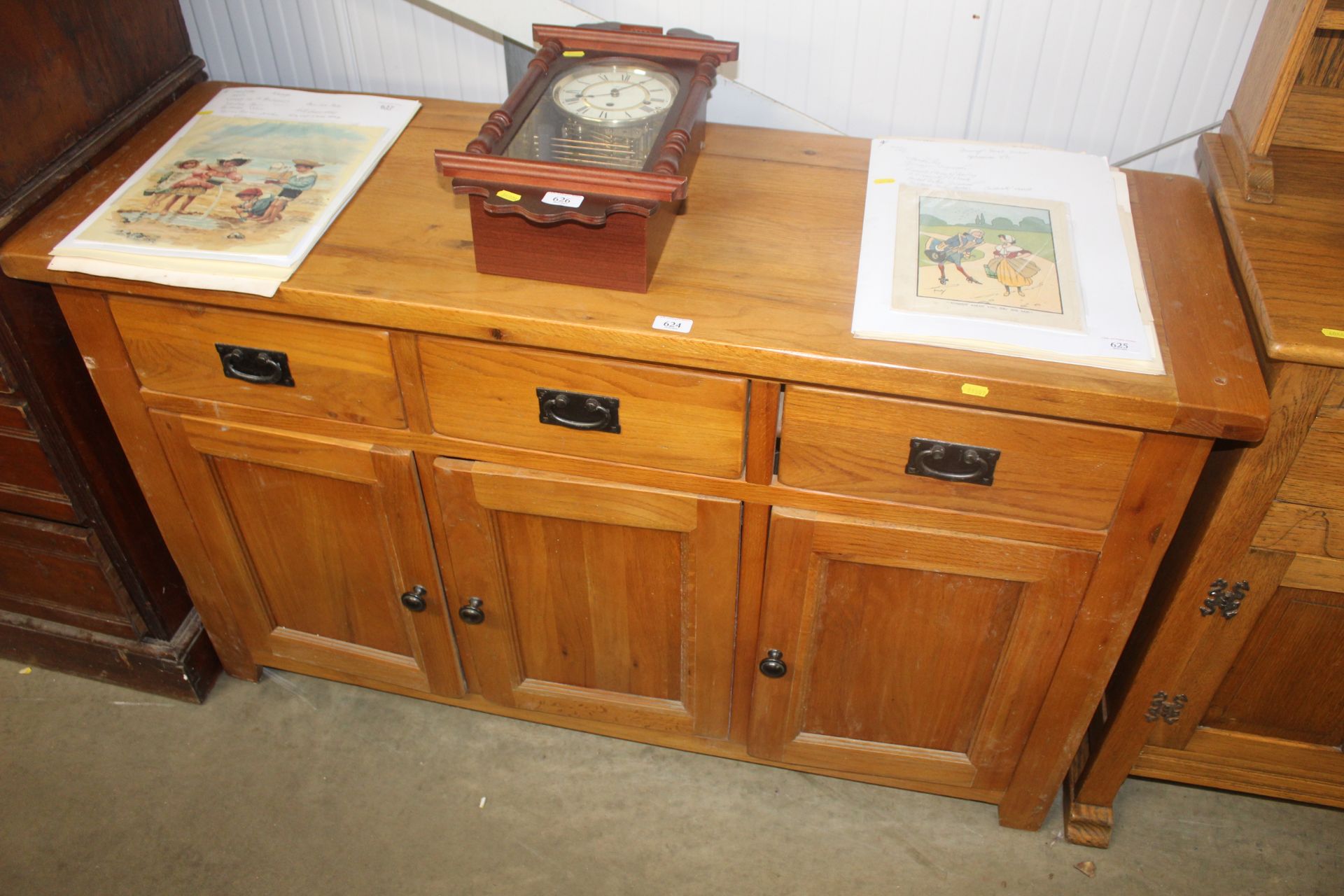 A modern light oak sideboard fitted three drawers