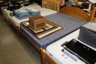 A pine double bed frame and mattress with four under bed storage drawers
