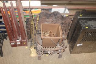 A cast iron fire back, a fire basket and set of im