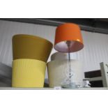 A modern table lamp and various shades