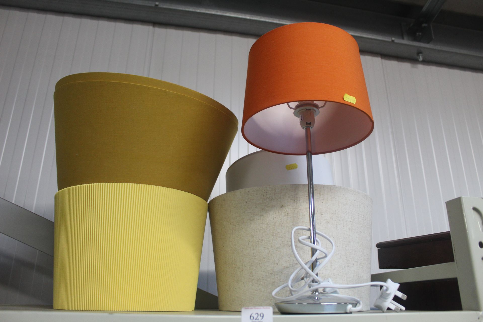 A modern table lamp and various shades