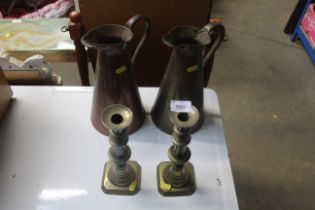 A pair of brass candlesticks and a pair of copper