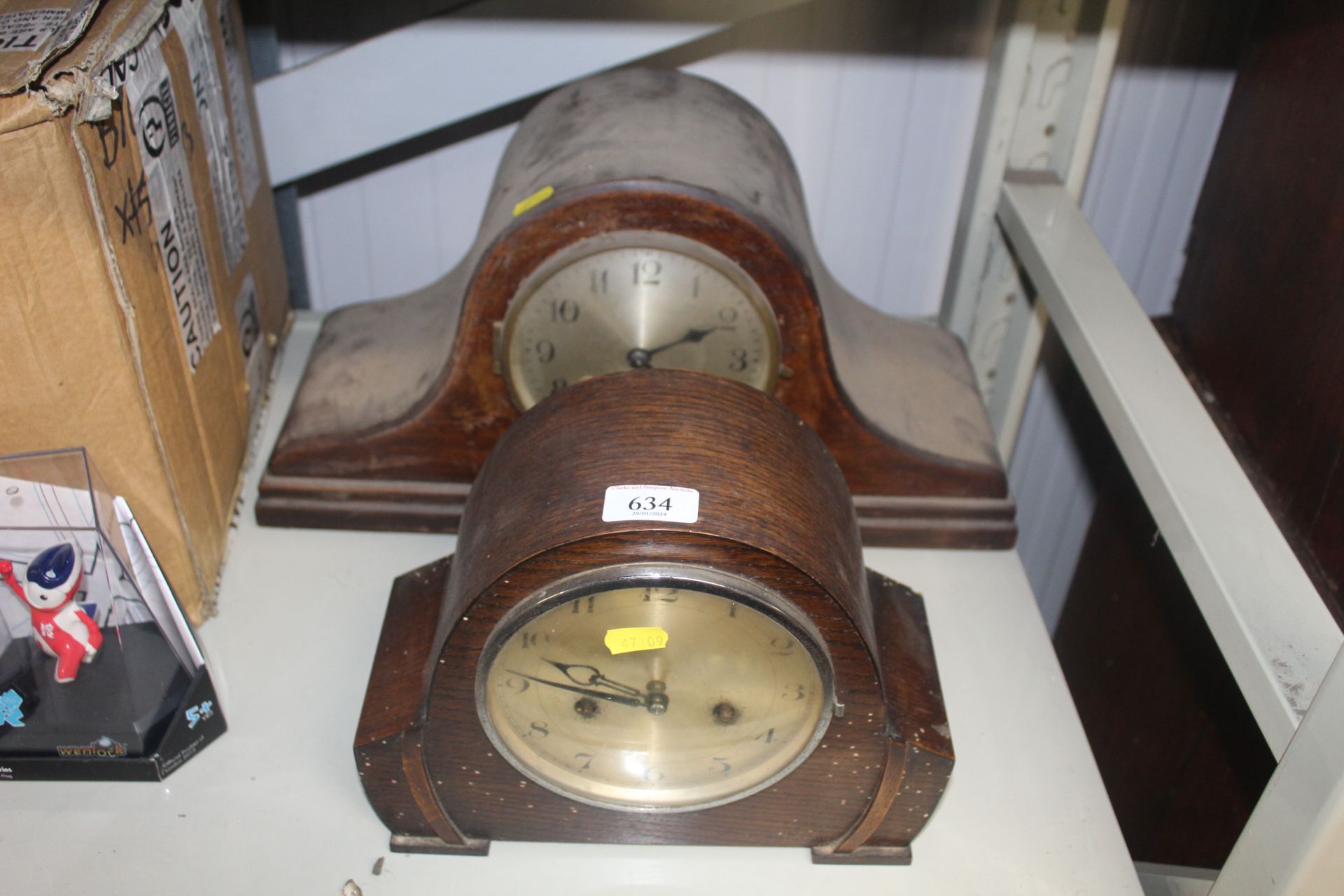 An oak cased two hole mantel clock and an oak case