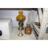 A copper oil lamp and two brass lamps