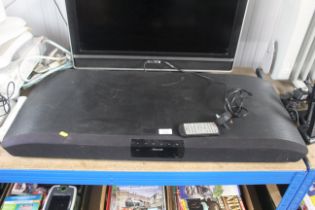 A Maxell TV sound bar with remote control